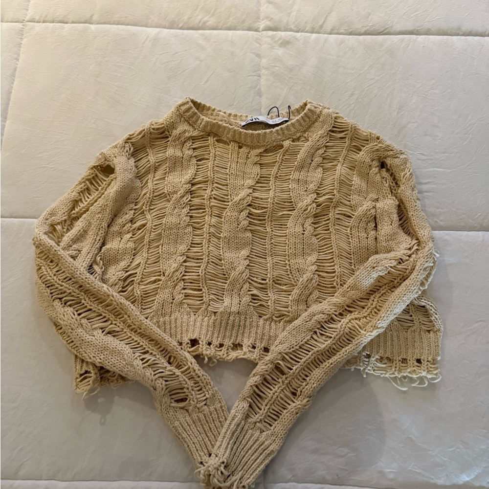 Cropped cable sweater